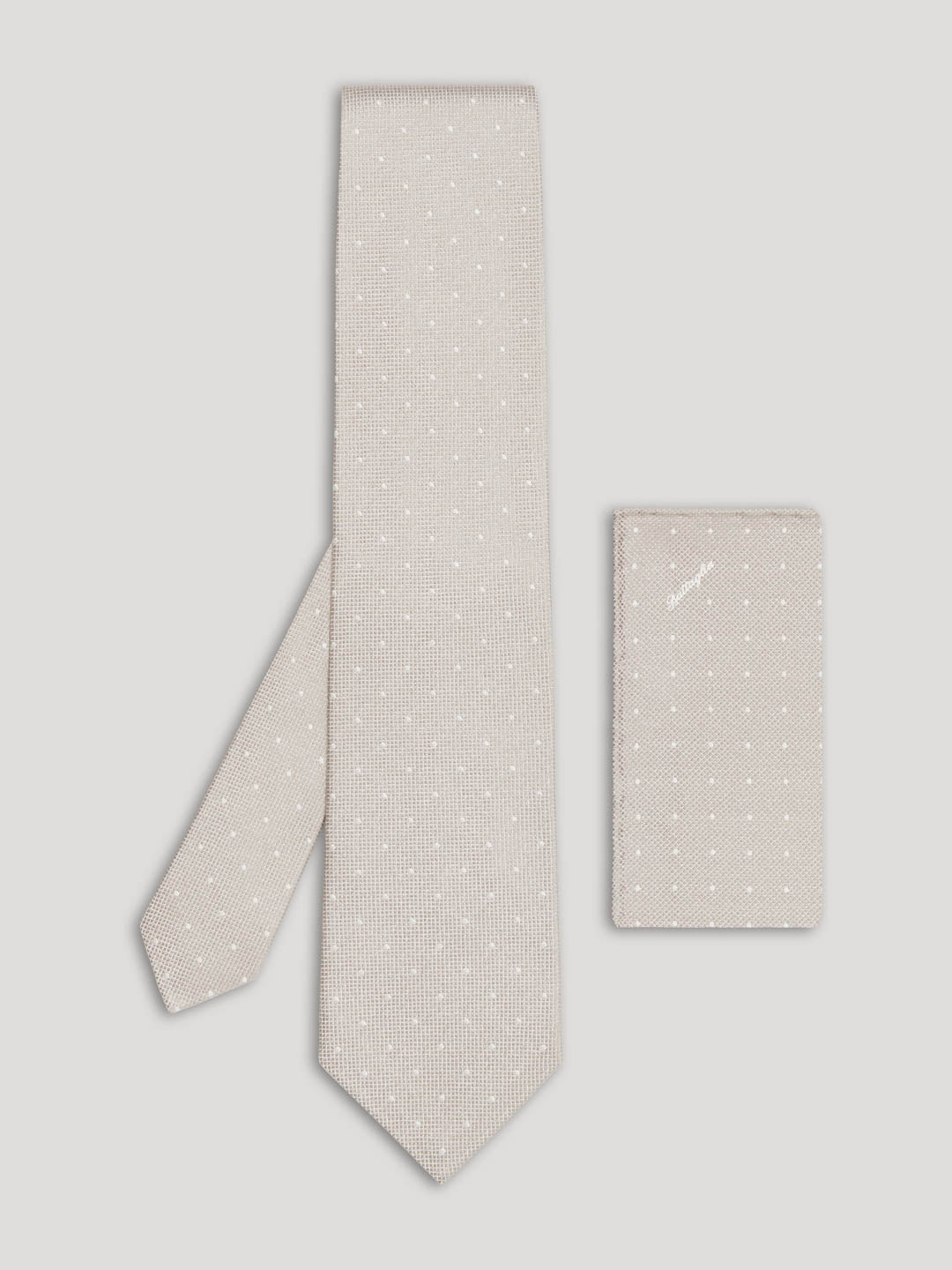 Light grey tie with white polkadots and matching handkerchief.