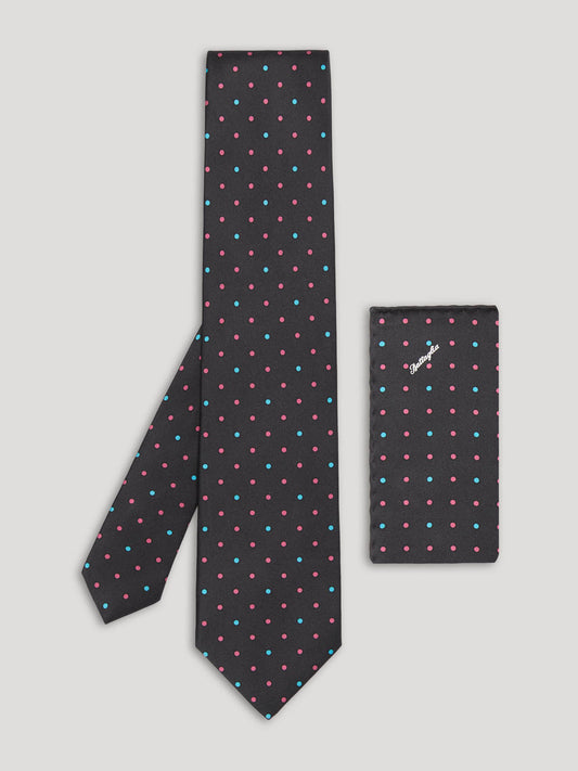 Black tie with pink and blue polkadots and matching handkerchief.