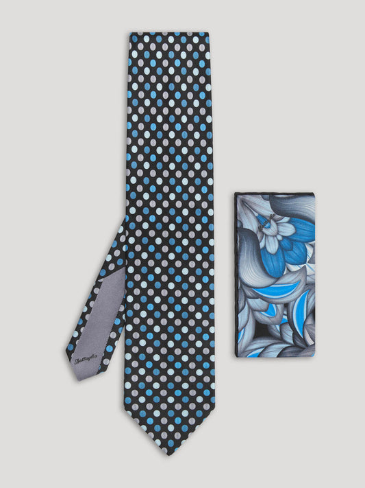 Black tie with blue and gray polkadots and matching handkerchief.