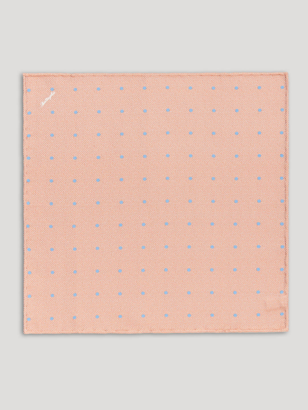 Light orange handkerchief with blue polkadots.