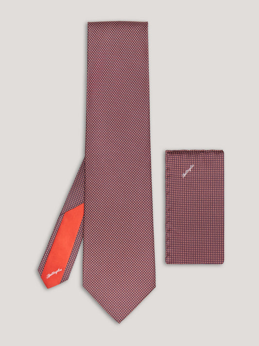 Red small pattern tie with matching handkerchief.