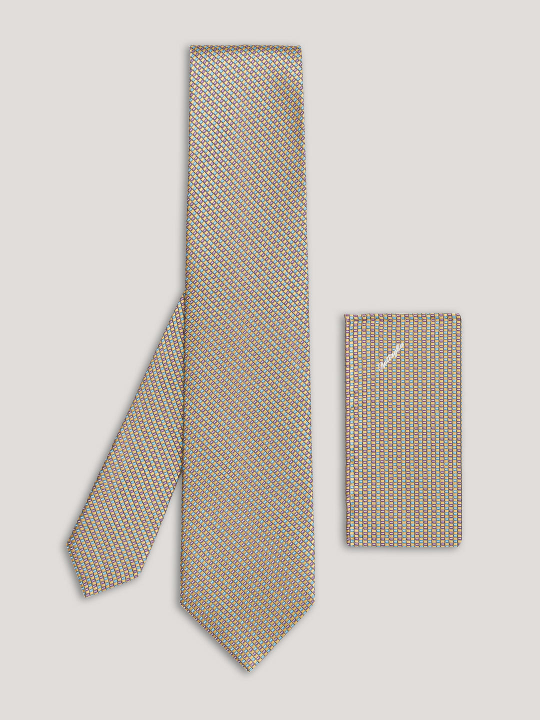 Beige tie with small pattern and matching handkerchief.