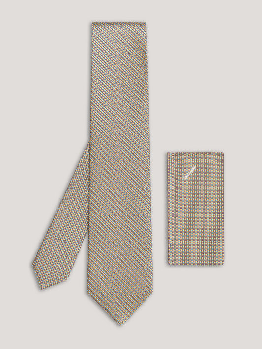 Beige tie with small pattern and matching handkerchief.