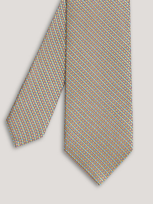 Beige tie with small pattern.