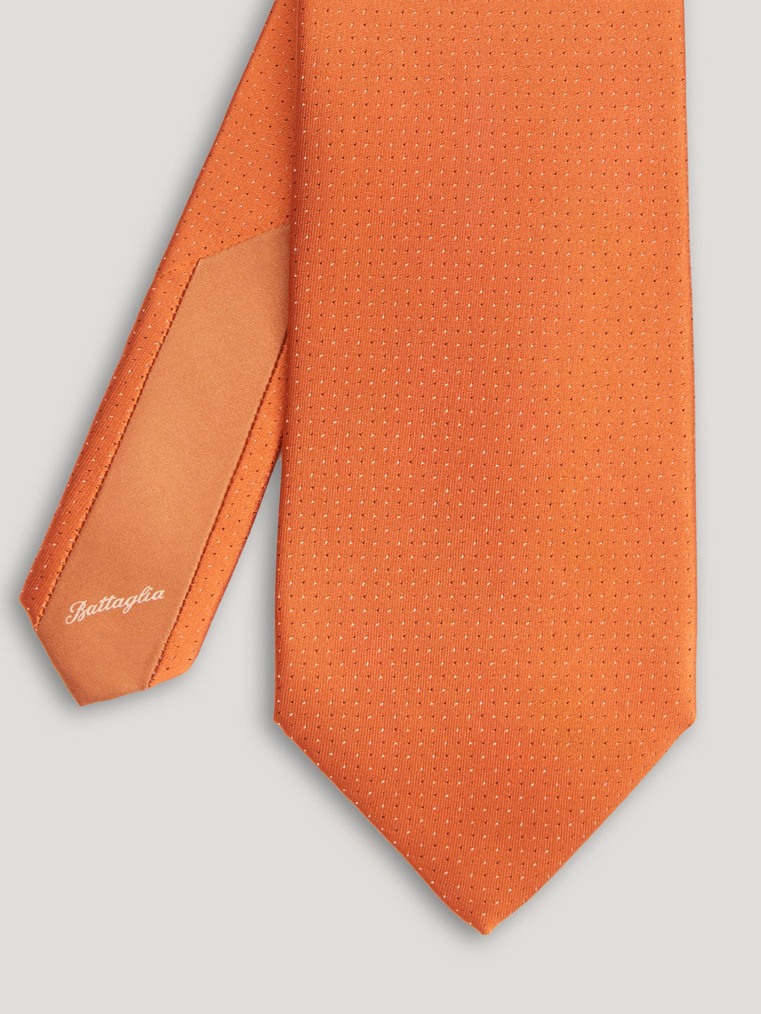 Orange tie with small pattern.
