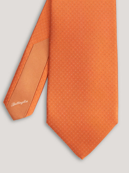 Orange tie with small pattern.