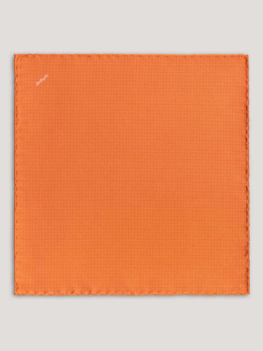 Orange handkerchief with small patter design. 