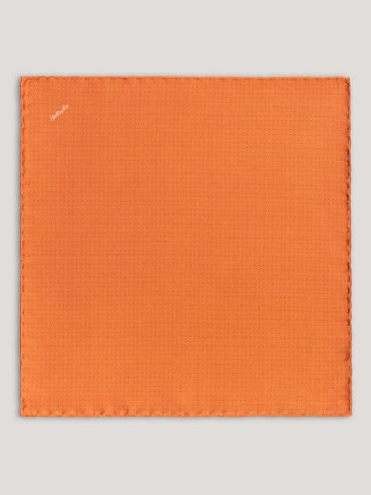 Orange handkerchief with small patter design. 