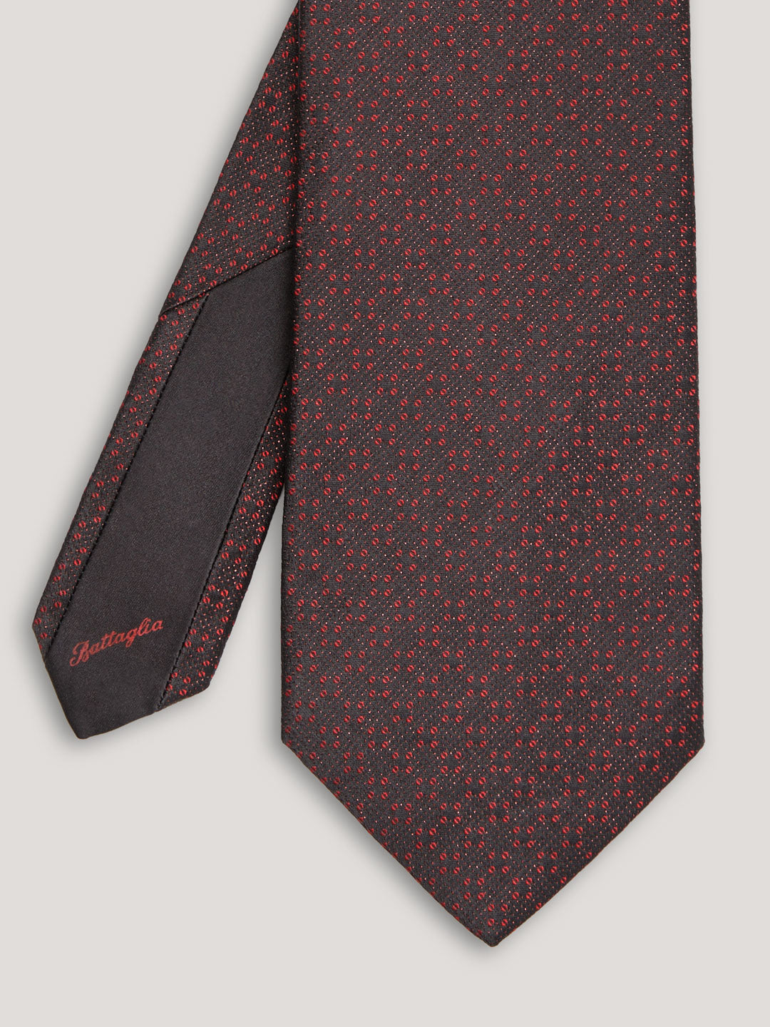 Red and black tie with small pattern. 