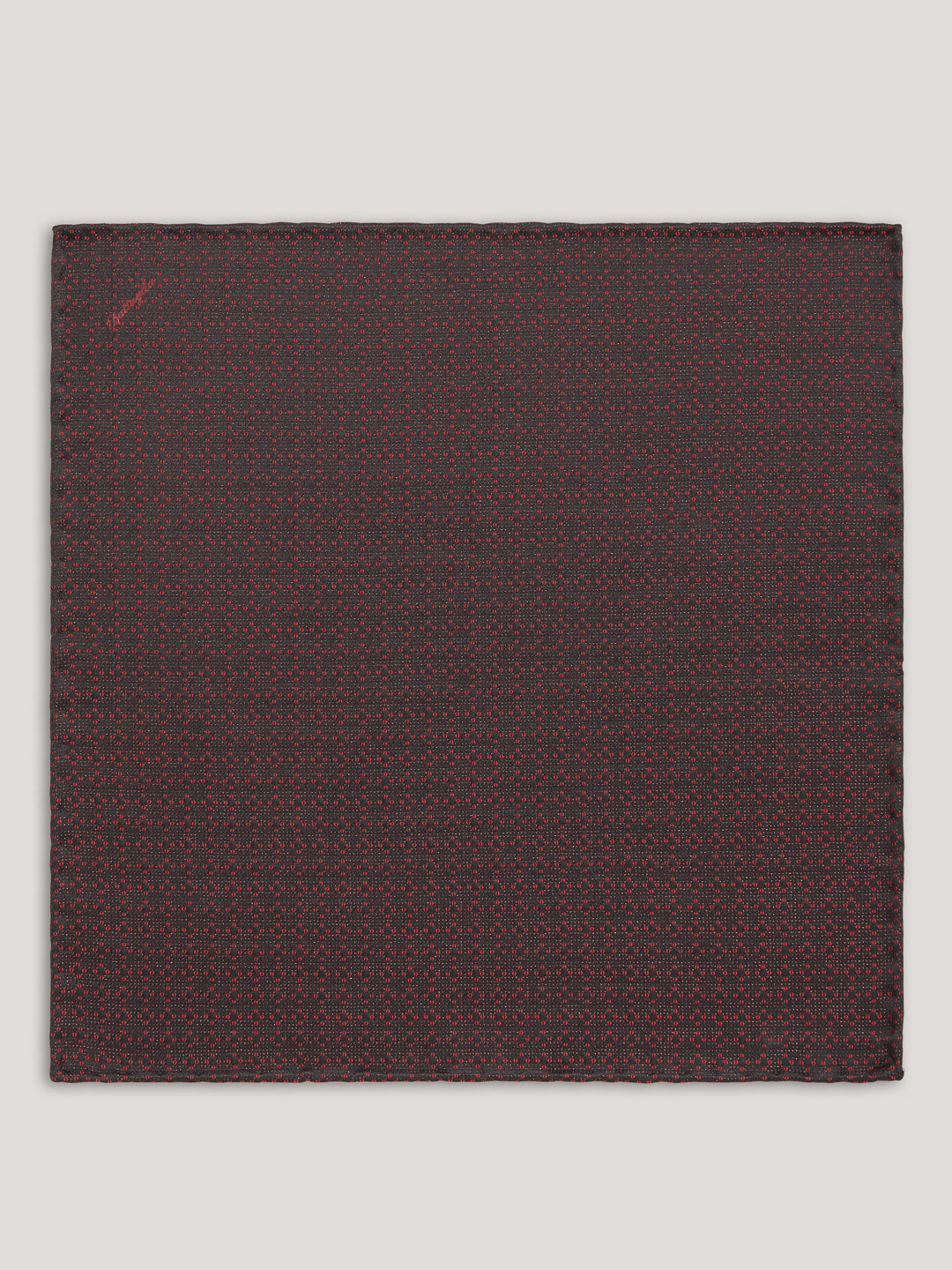 Red and black handkerchief with small pattern design.