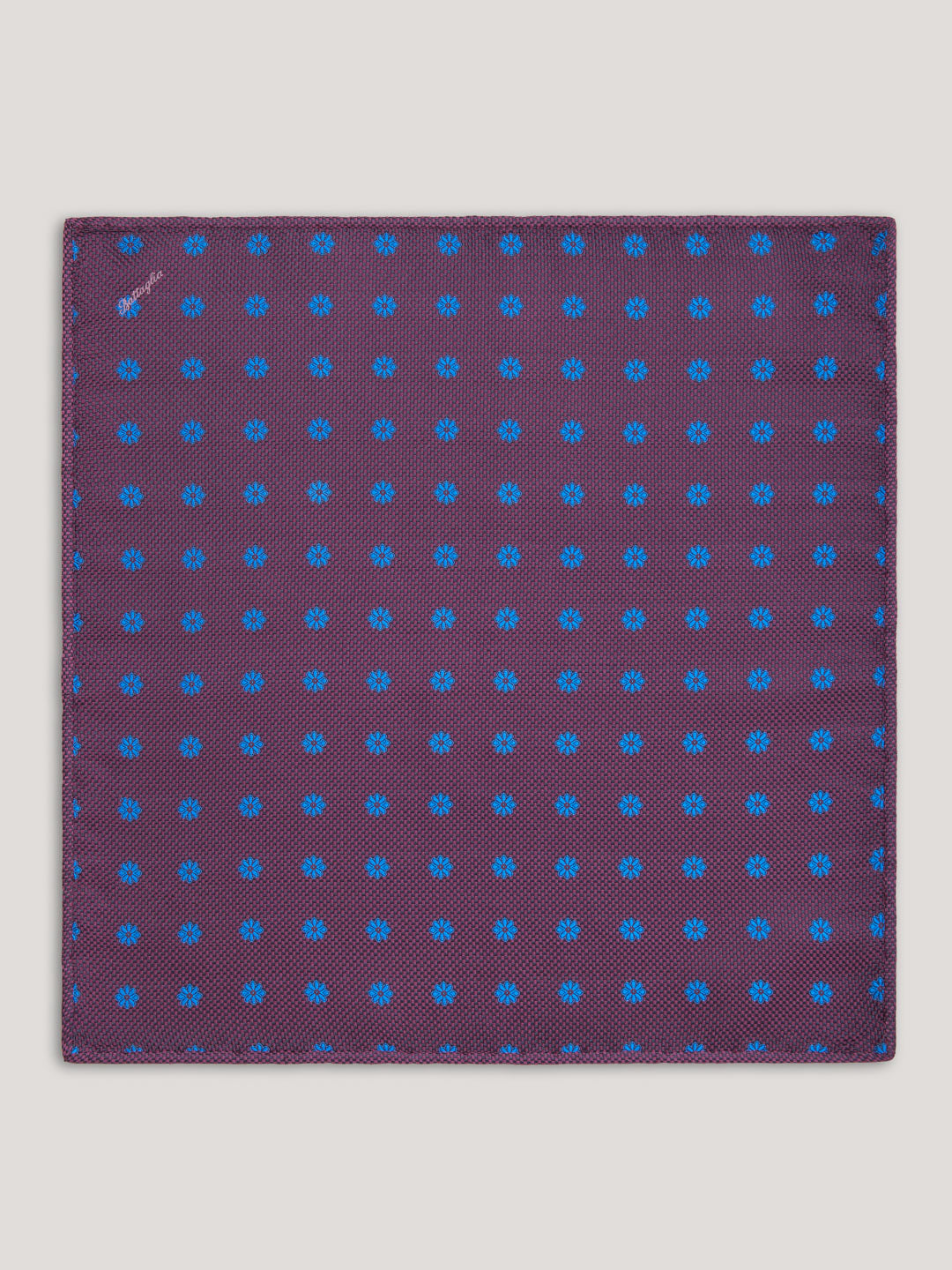 Purple handkerchief with small blue pattern design. 