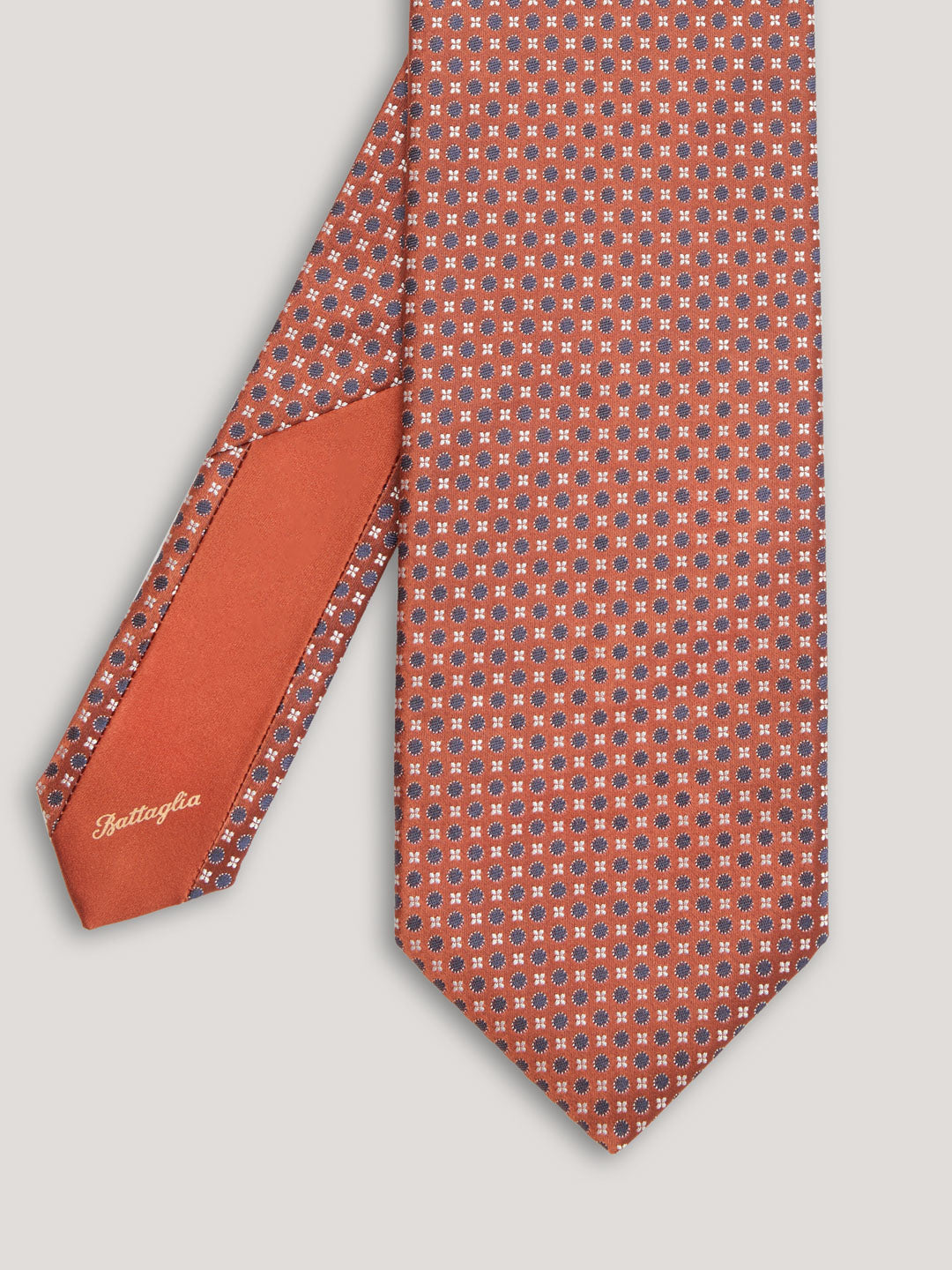 Orange tie with blue small pattern design.