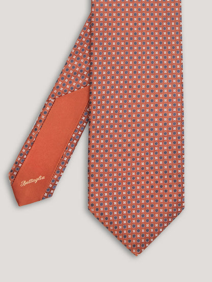 Orange tie with blue small pattern design.  