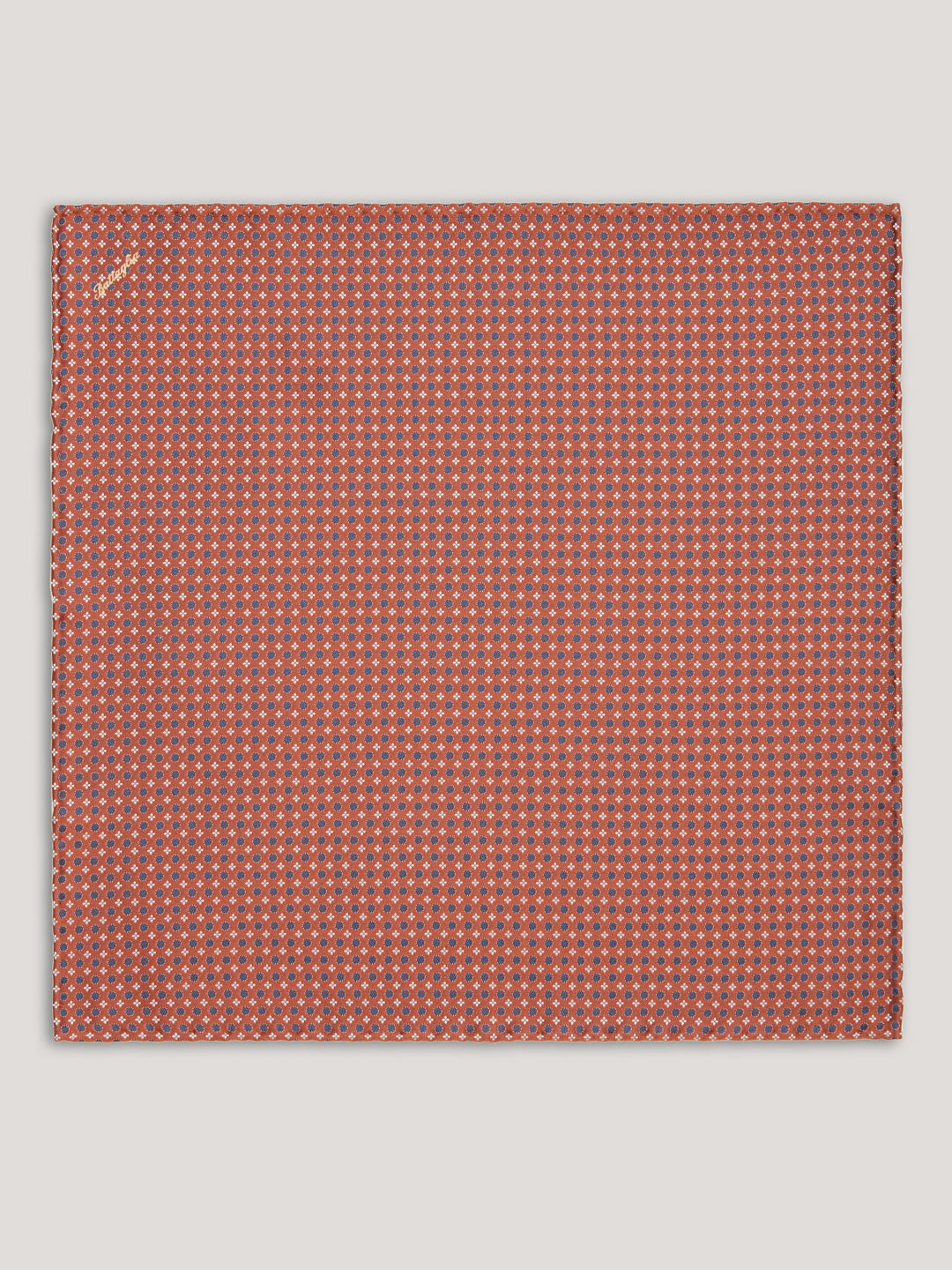 Orange handkerchief with blue small pattern design. 