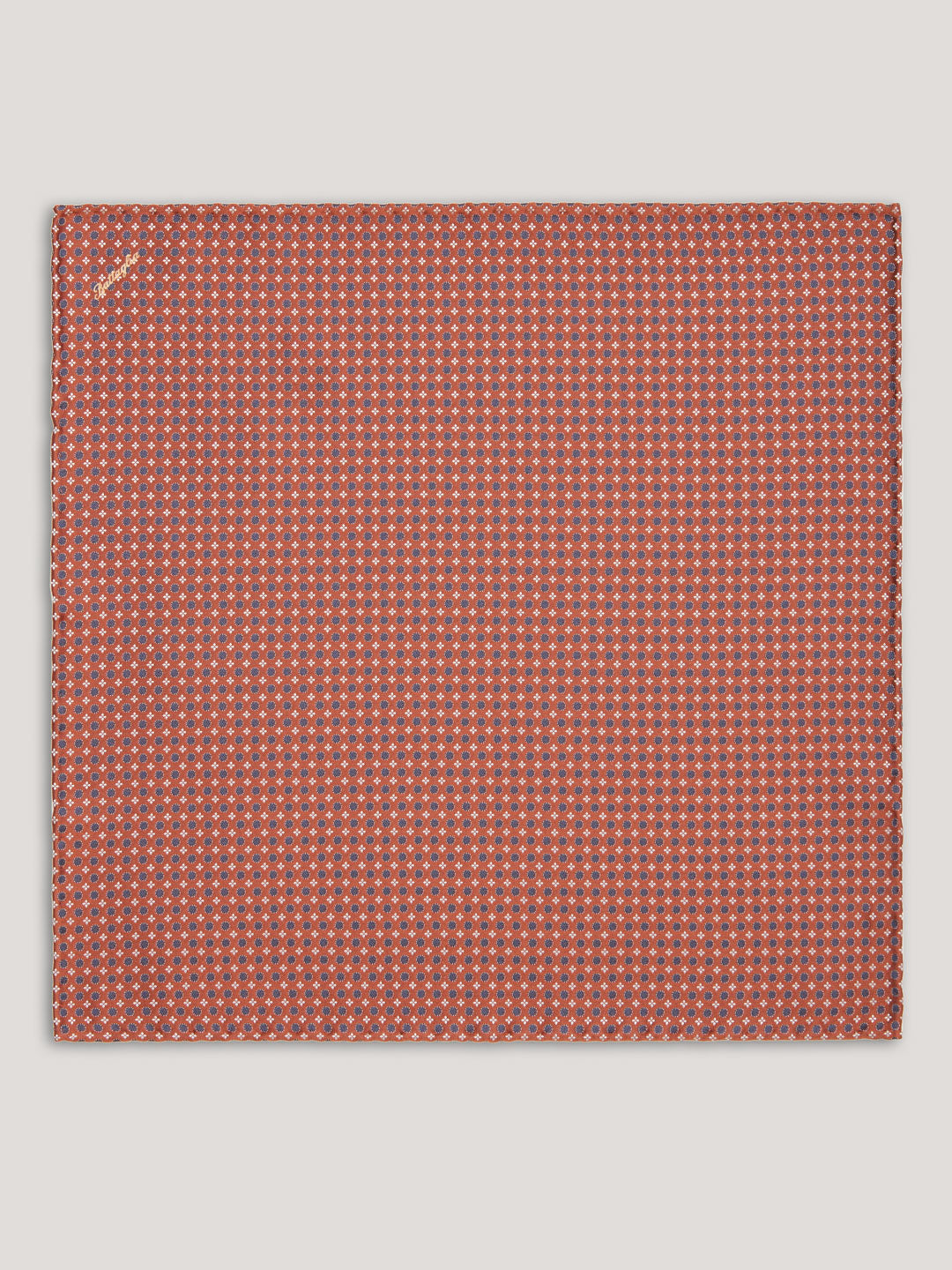 Orange handkerchief with blue small pattern design.