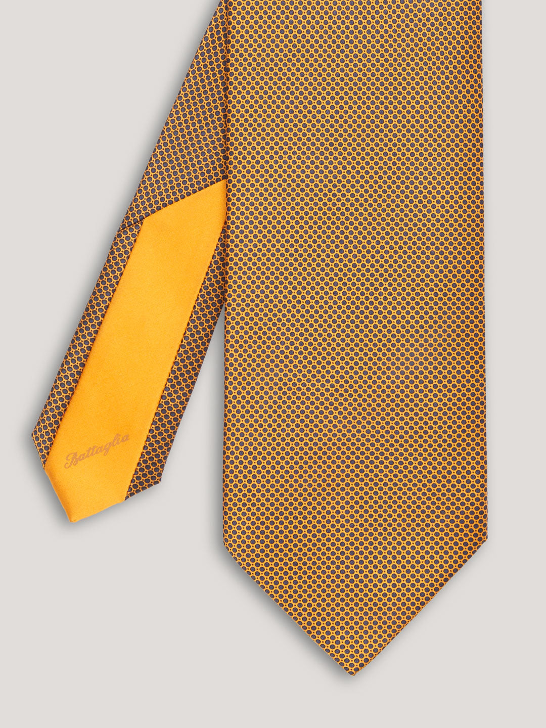 Yellow tie with small black pattern design.  