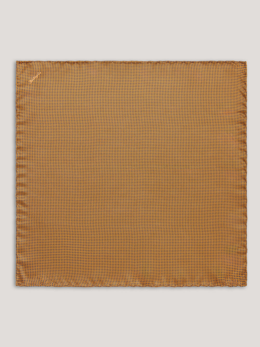 Yellow handkerchief with small black pattern design.