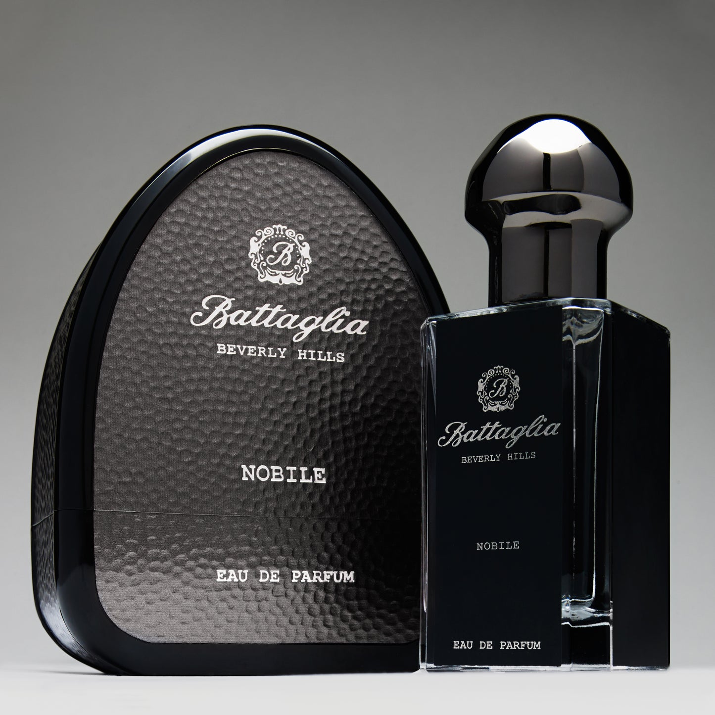 Nobile is a deep fragrance with notes of bergamot, pimento, cedar and white musk. Photo shows the Nobile Bottle next to its dark gray box.