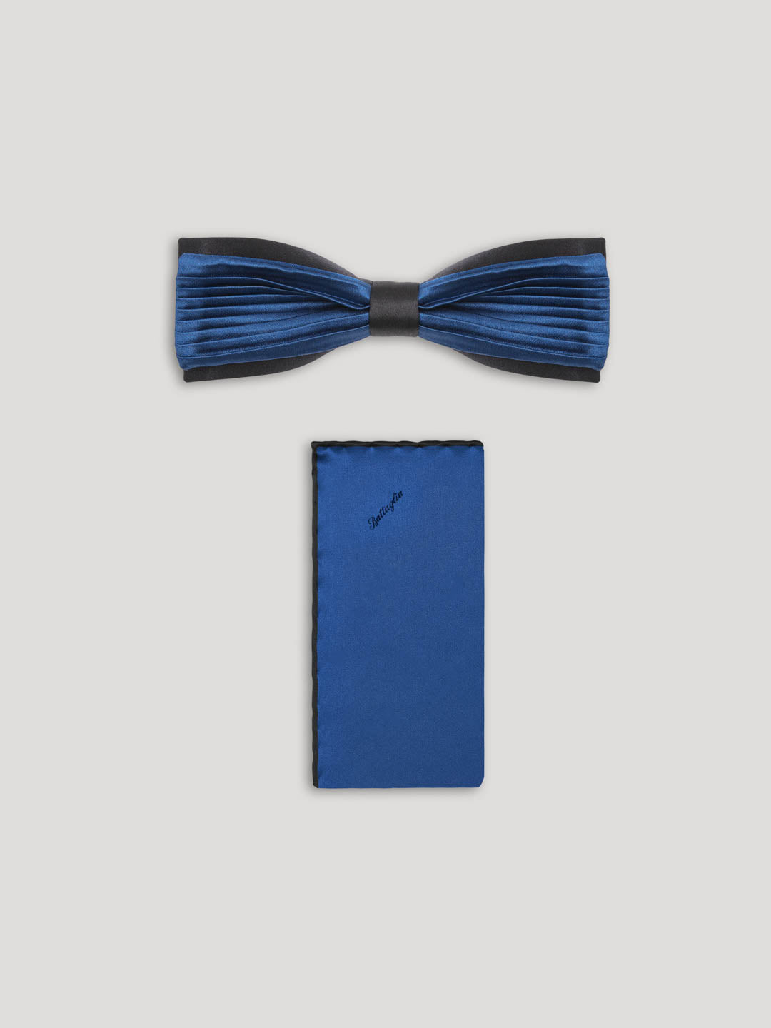 Blue pleated silk bow tie with matching handkerchief.