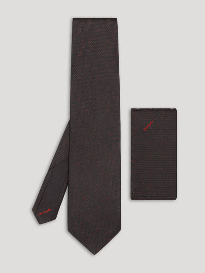 Black tie with red polkadots and matching handkerchief. 
