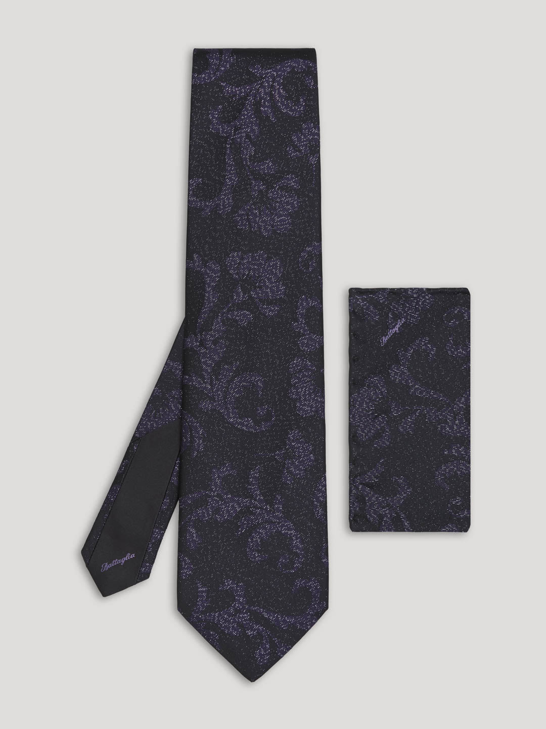 Black tie with floral design and handkerchief. 