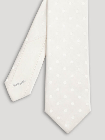 White silk tie with polkadots.