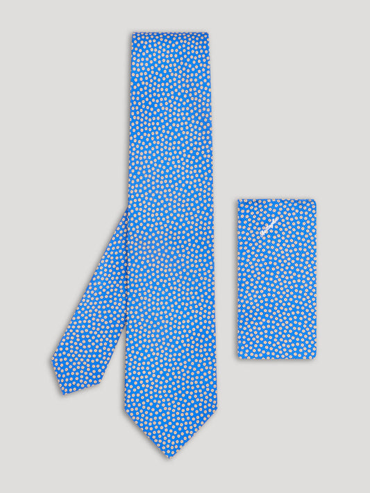 Light blue floral tie with white and yellow floral details and matching handkerchief.