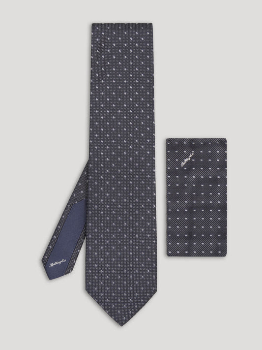 Black tie with silver geometric design and matching handkerchief. 