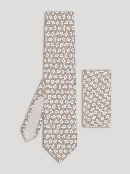 Beige and white paisley tie with matching handkerchief. 