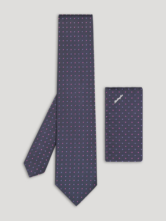 Purple tie with pink and blue polkadots and matching handkerchief. 