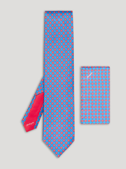 Blue tie with red polkadots and matching handkerchief. 