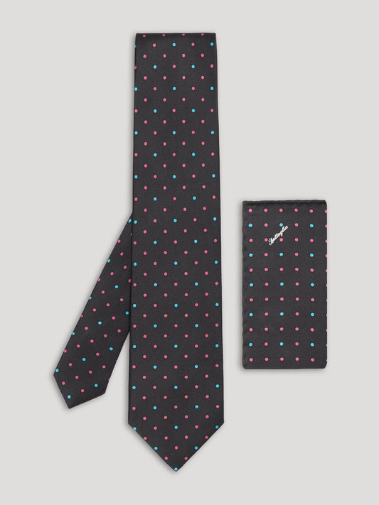 Black tie with pink and blue polkadots and matching handkerchief. 